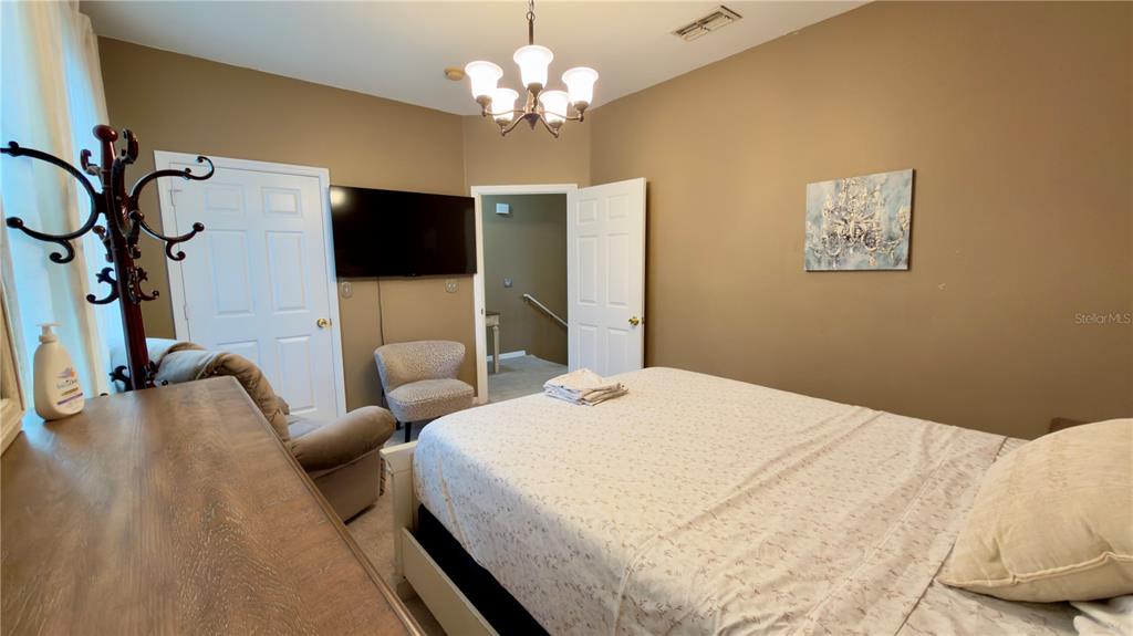 6624 Time Square Avenue, Unit 102 Orlando, FL 32835 - Photo 53 of 96 a bedroom with a bed and a flat screen tv