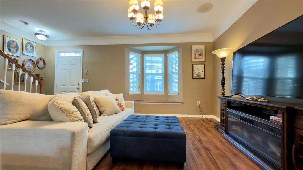 6624 Time Square Avenue, Unit 102 Orlando, FL 32835 - Photo 7 of 96 a bedroom with a bed and a chandelier