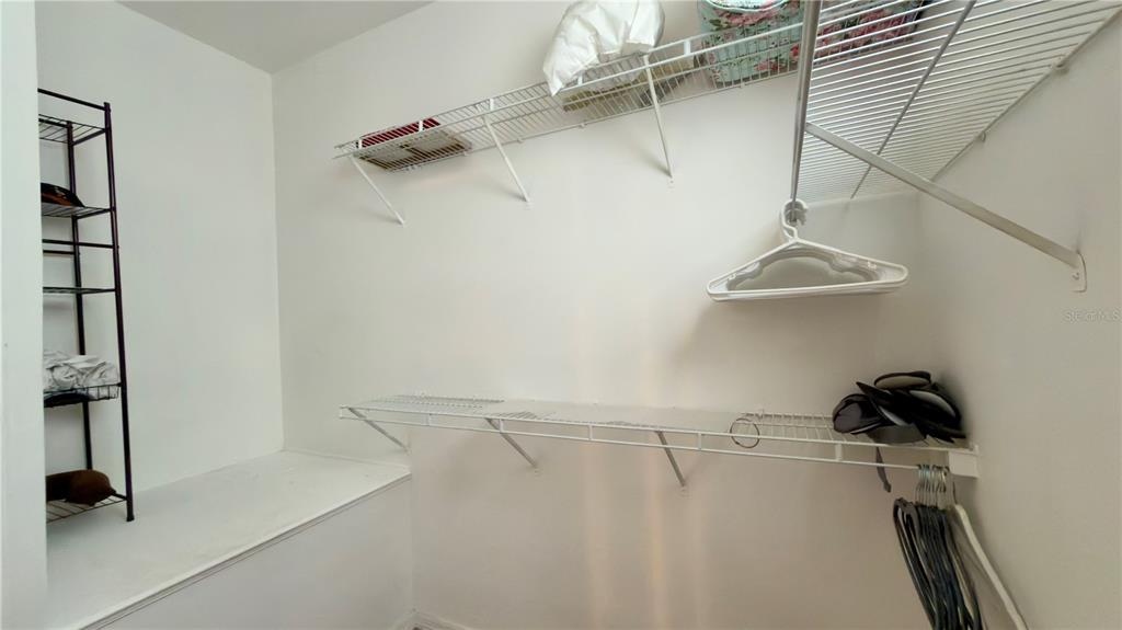 6624 Time Square Avenue, Unit 102 Orlando, FL 32835 - Photo 74 of 96 a view of walk in closet with clothes and shoes