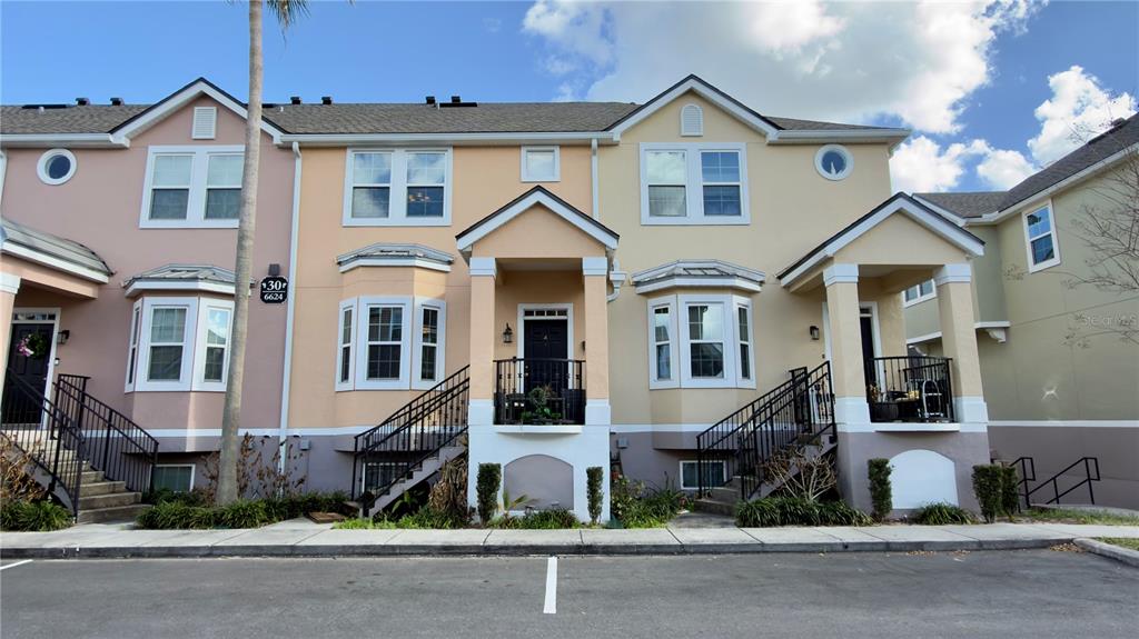 6624 Time Square Avenue, Unit 102 Orlando, FL 32835 - Photo 88 of 96 a front view of a house with a yard