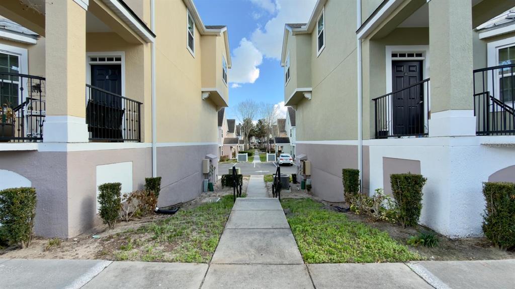6624 Time Square Avenue, Unit 102 Orlando, FL 32835 - Photo 91 of 96 a view of a brick house with many windows next to a yard