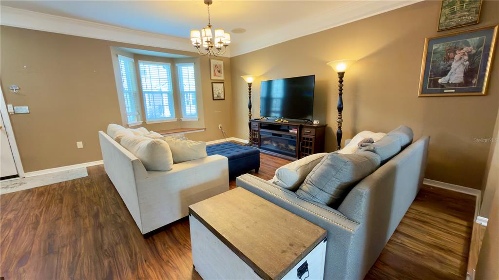 6624 Time Square Avenue, Unit 102 Orlando, FL 32835 - Photo 10 of 96 a living room with furniture and a flat screen tv