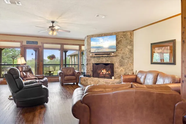 a living room with furniture a large window and a fireplace