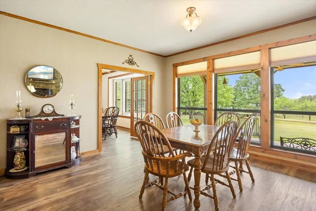 a view of a dining room with furniture window and wooden floor