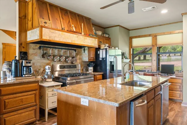 a kitchen with stainless steel appliances granite countertop a sink and cabinets