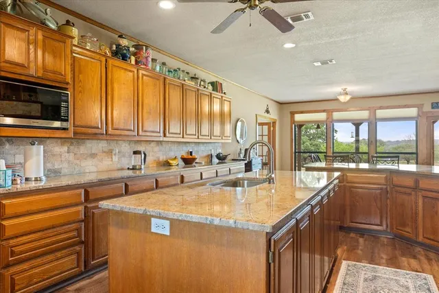 a kitchen with stainless steel appliances granite countertop a sink and cabinets