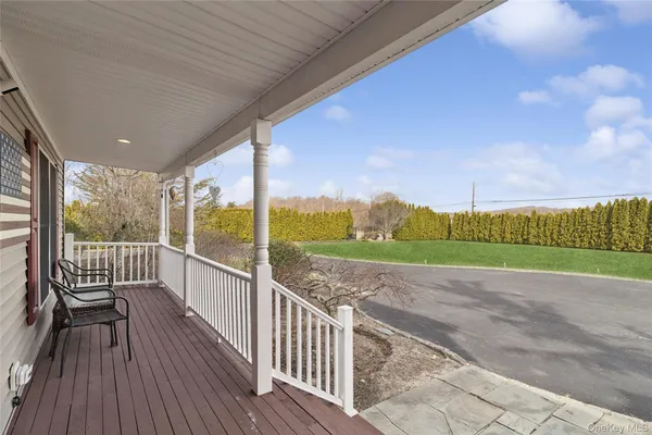 a view of a porch with wooden floor and fence