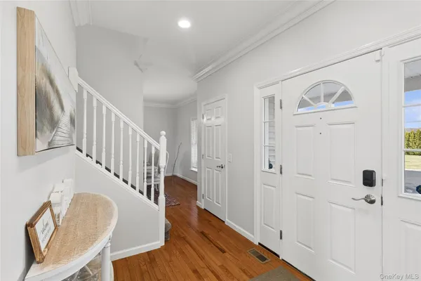 a view of an entryway with wooden floor
