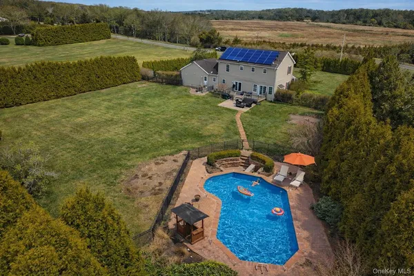 an aerial view of a house with a yard basket ball court and outdoor seating