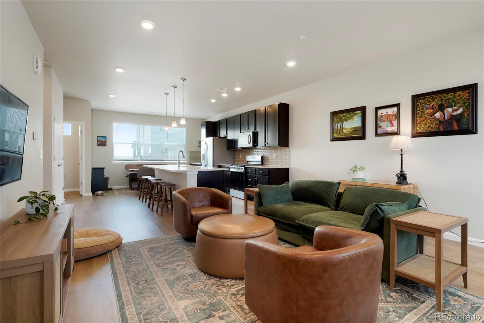 6974 Merseyside Lane Castle Pines, CO 80108 - Photo 11 of 27 a living room with furniture and a view of kitchen
