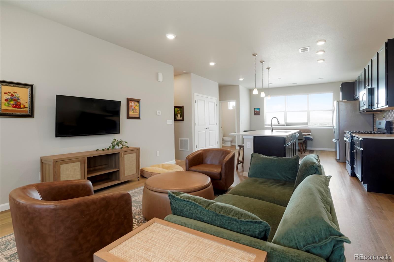 6974 Merseyside Lane Castle Pines, CO 80108 - Photo 12 of 27 a living room with furniture and a flat screen tv