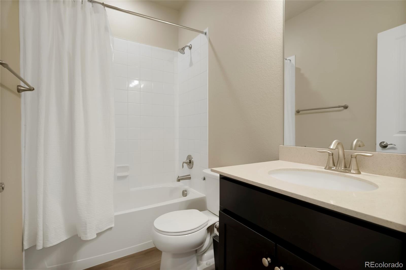 6974 Merseyside Lane Castle Pines, CO 80108 - Photo 15 of 27 a bathroom with a sink and a mirror