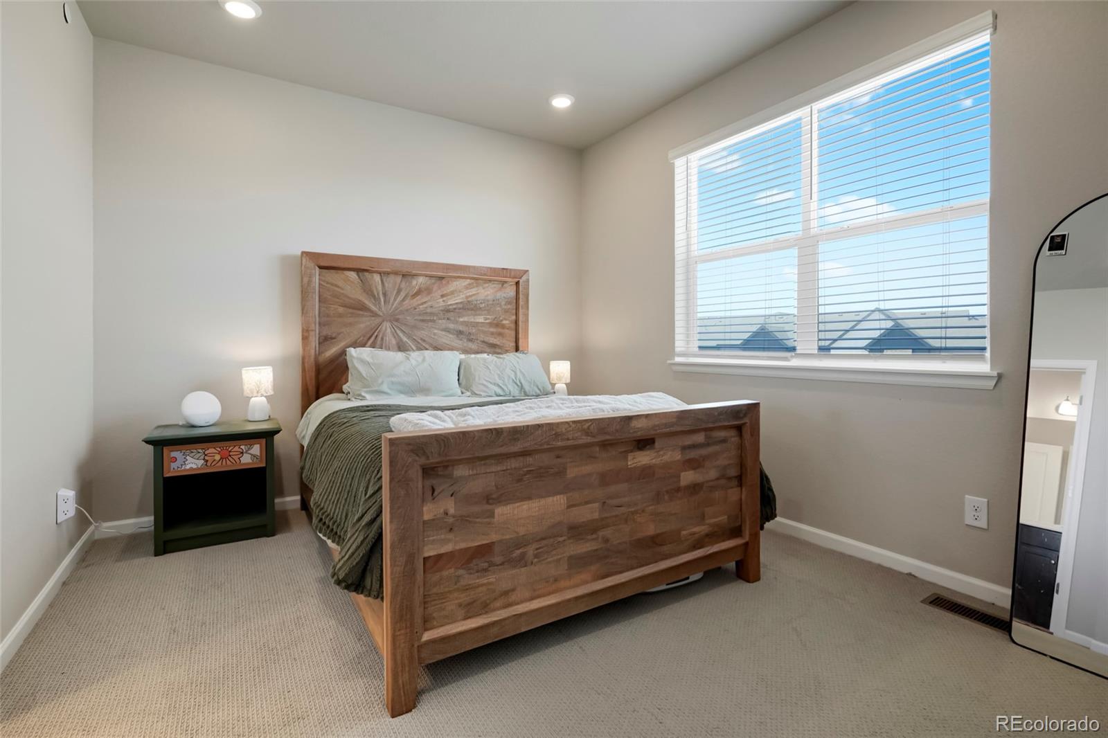 6974 Merseyside Lane Castle Pines, CO 80108 - Photo 17 of 27 a bed sitting in a bedroom next to a window