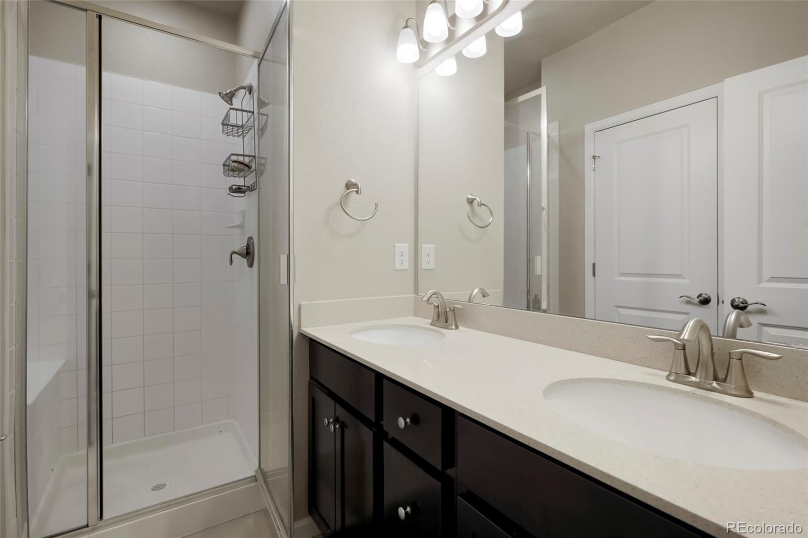 6974 Merseyside Lane Castle Pines, CO 80108 - Photo 20 of 27 a bathroom with a sink double vanity and a mirror