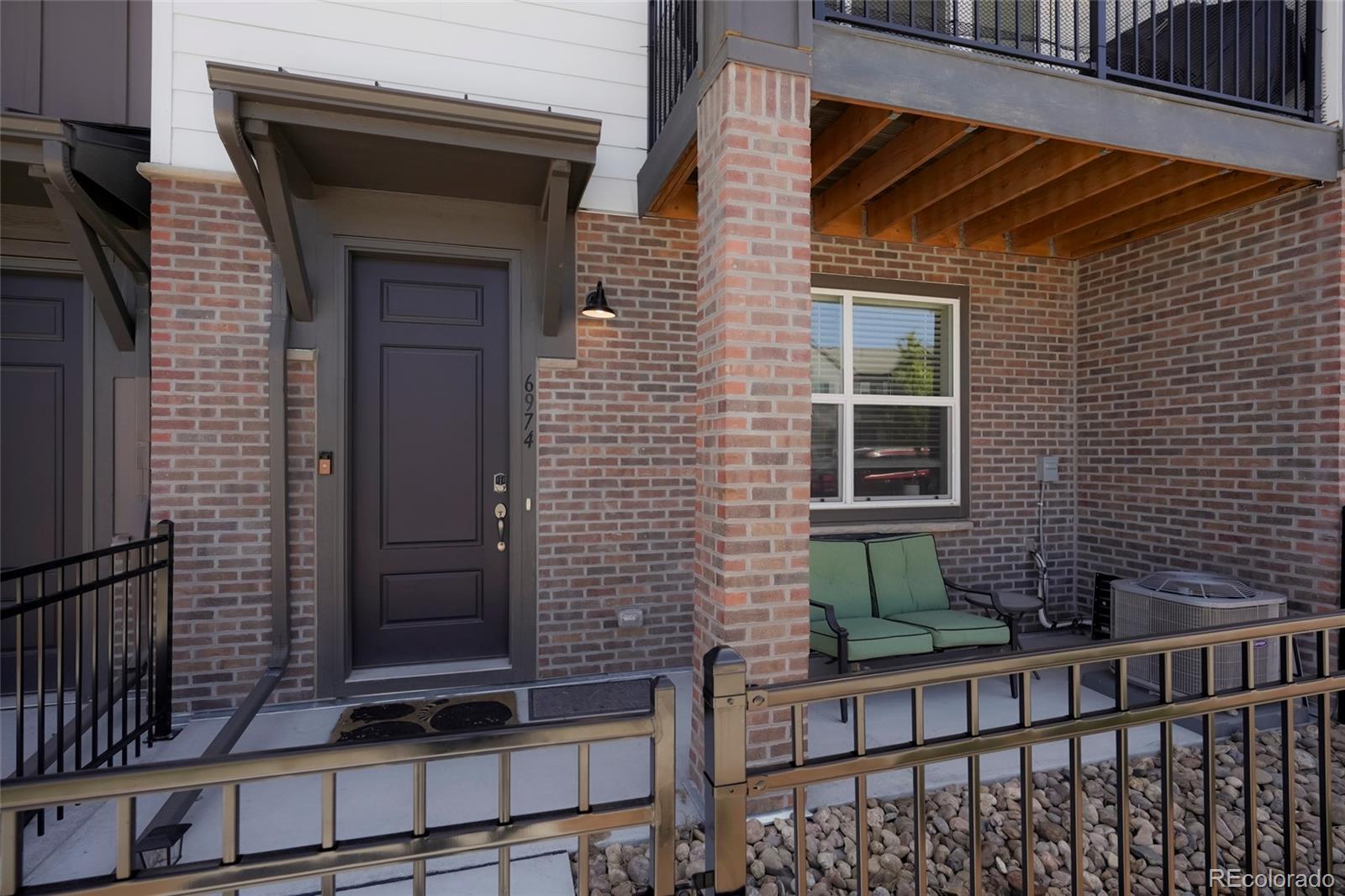 6974 Merseyside Lane Castle Pines, CO 80108 - Photo 2 of 27 a view of house with wooden door