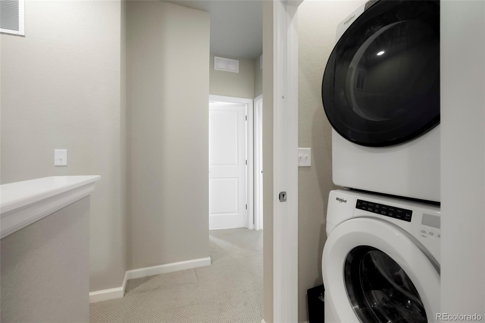 6974 Merseyside Lane Castle Pines, CO 80108 - Photo 21 of 27 a view of a hallway with washer and dryer