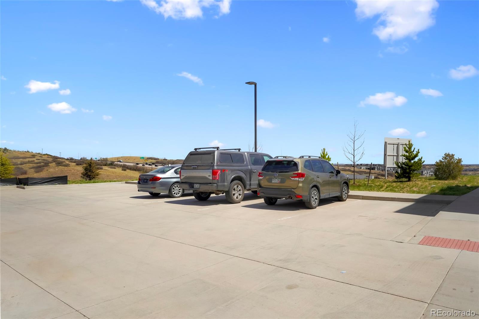 6974 Merseyside Lane Castle Pines, CO 80108 - Photo 25 of 27 a car parked on the side of the road