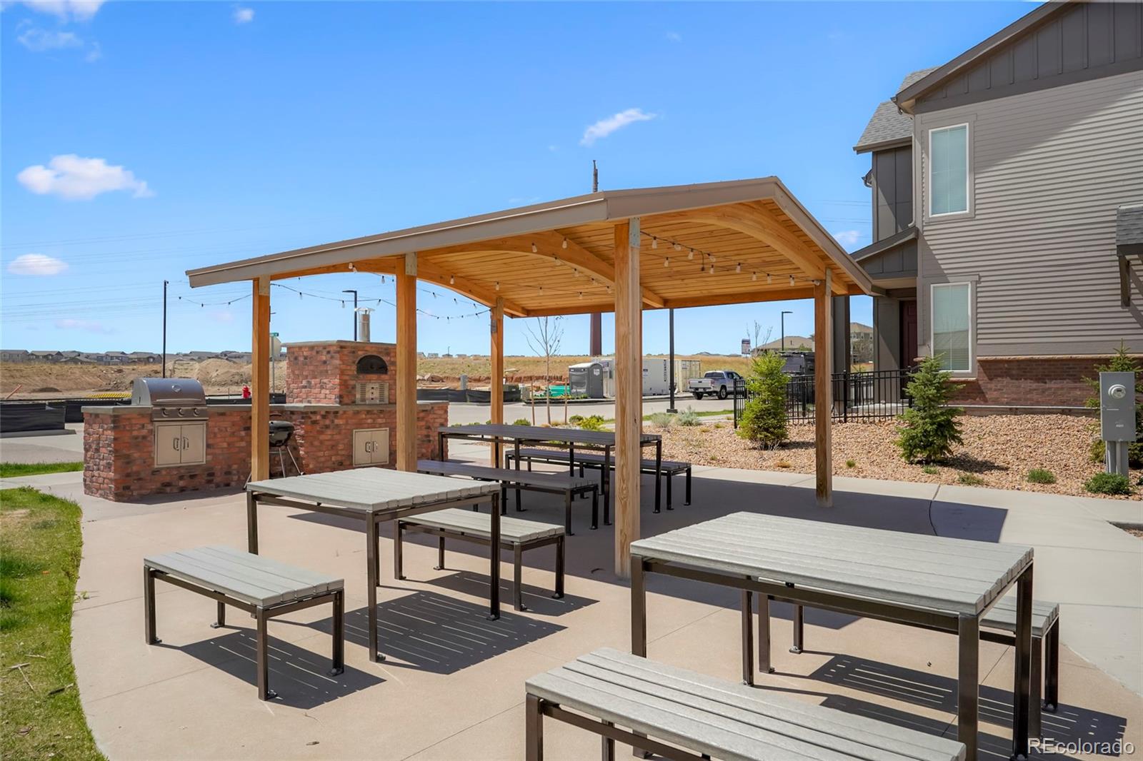 6974 Merseyside Lane Castle Pines, CO 80108 - Photo 27 of 27 a view of a patio with a table and chairs under an umbrella