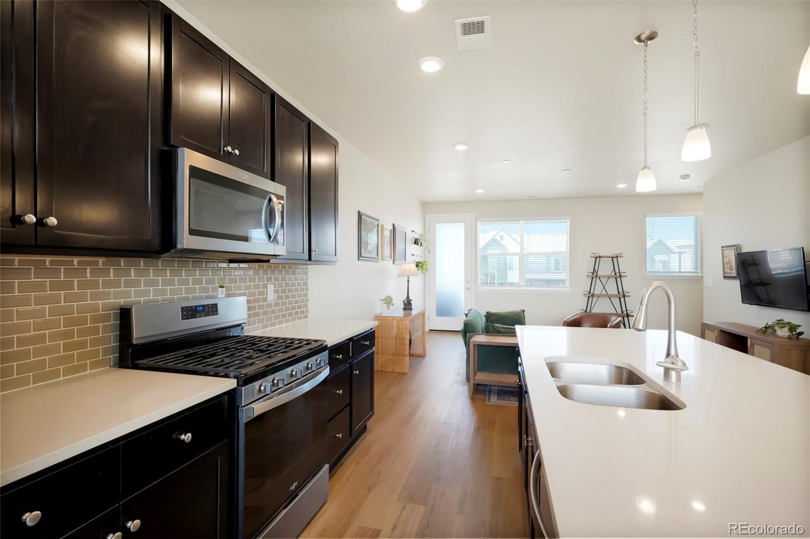 6974 Merseyside Lane Castle Pines, CO 80108 - Photo 9 of 27 a large kitchen with stainless steel appliances