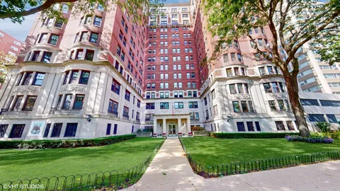 a view of a brick building next to a yard