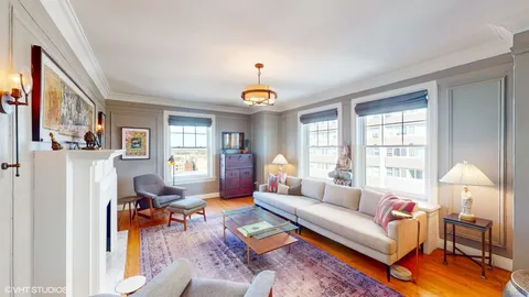 a living room with furniture dining table and a window
