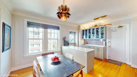 a living room with kitchen island furniture and a chandelier