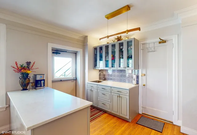 a kitchen with a sink a stove and a refrigerator