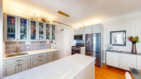 a kitchen that has a refrigerator and a sink