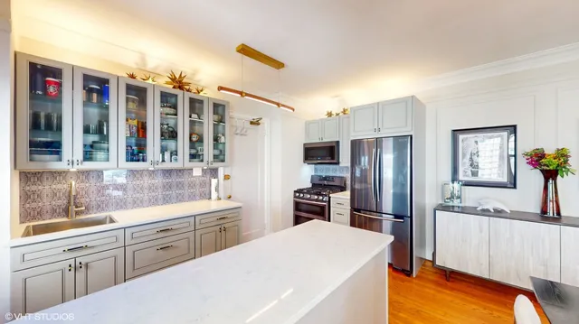 a kitchen that has a refrigerator and a sink