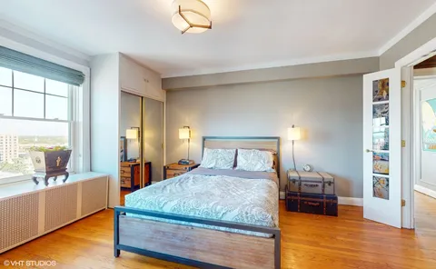 a bedroom with a large bed and a large window