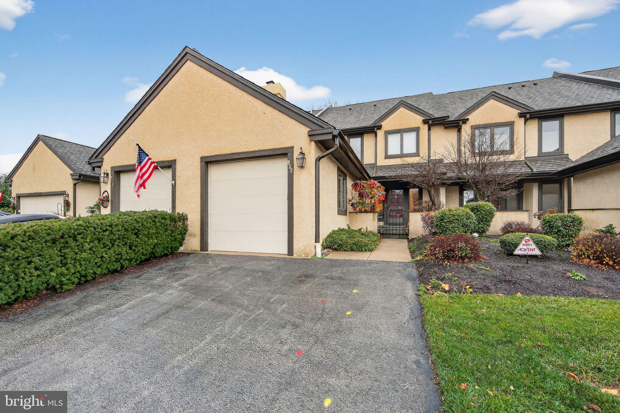 a view of a house with a small yard and potted plants