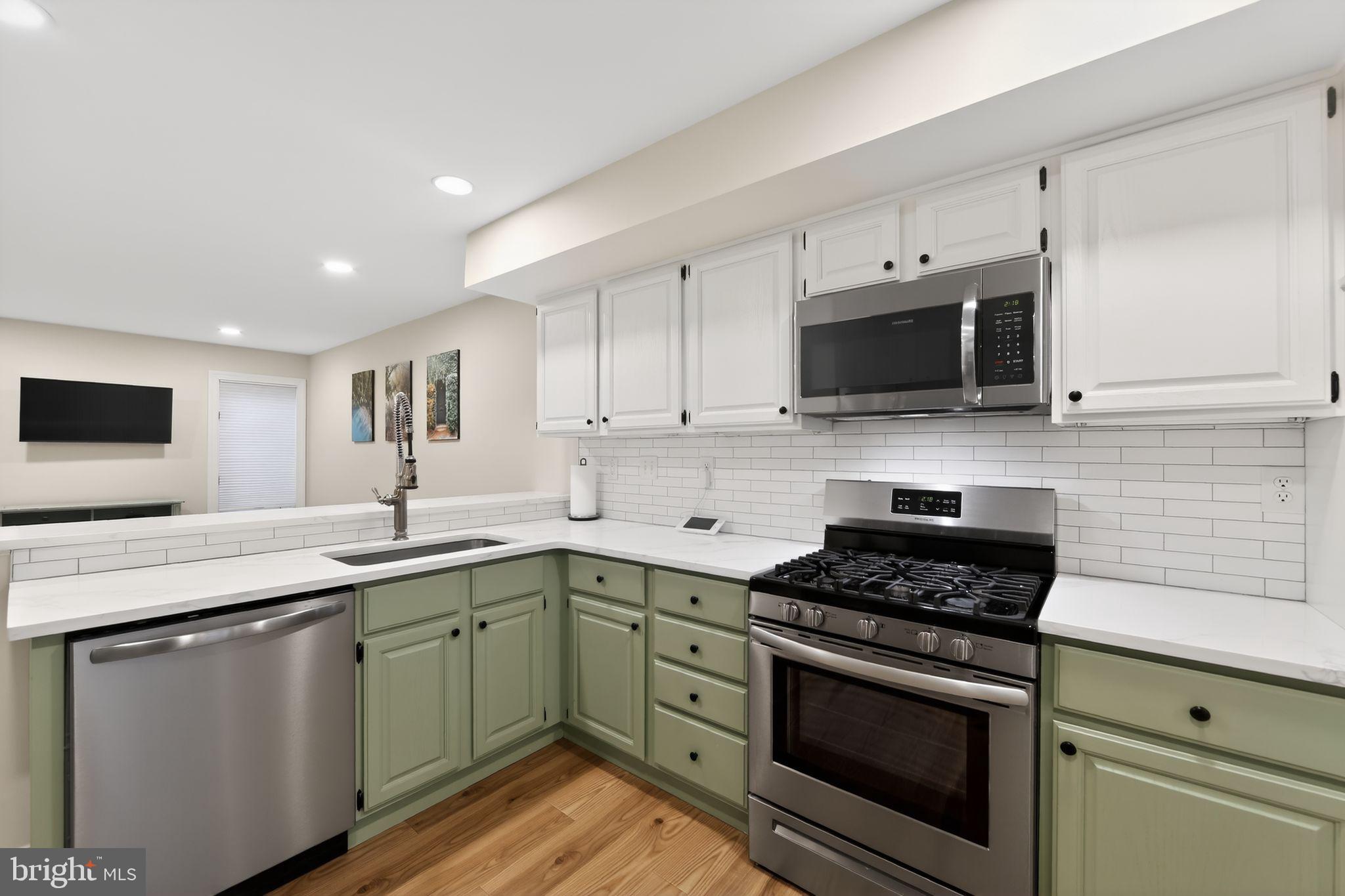 932 Hedgerow Court Blue Bell, PA 19422 - Photo 11 of 40 a kitchen with stainless steel appliances granite countertop a sink a stove top oven and white cabinets