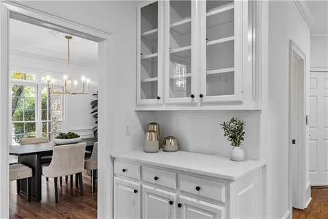 a living room with furniture a clock and a window