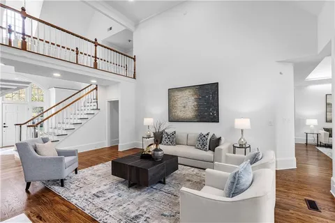 a kitchen with stainless steel appliances a table chairs and a refrigerator