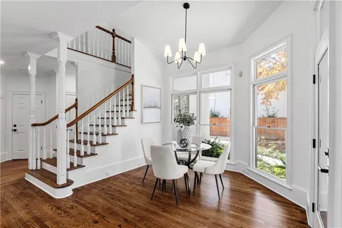 a kitchen with stainless steel appliances white cabinets and a stove top oven