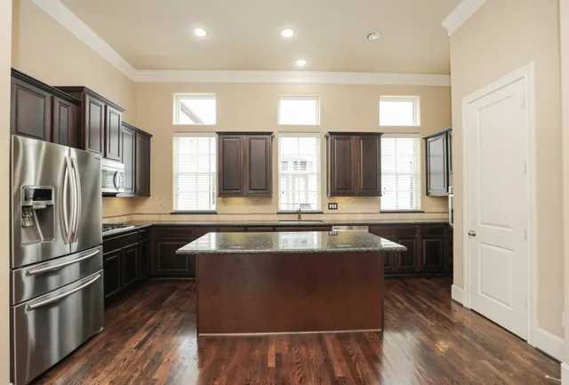 a view of a kitchen with a sink and refrigerator
