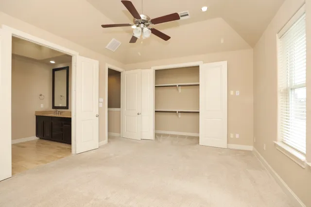 a spacious bathroom with a double vanity sink a mirror and a shower