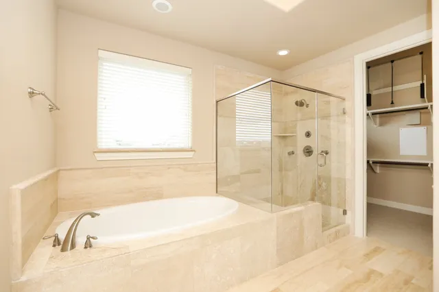 a white bath tub sitting next to a shower