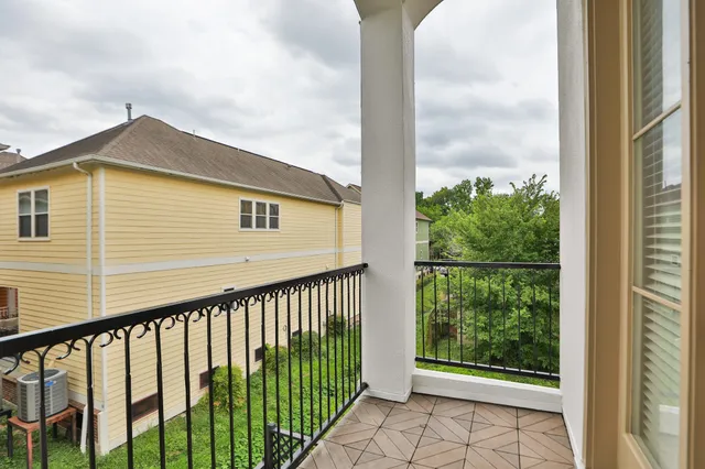 a view of balcony with wooden floor