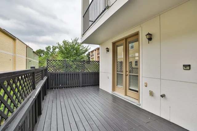 a view of a wooden deck with a barbeque