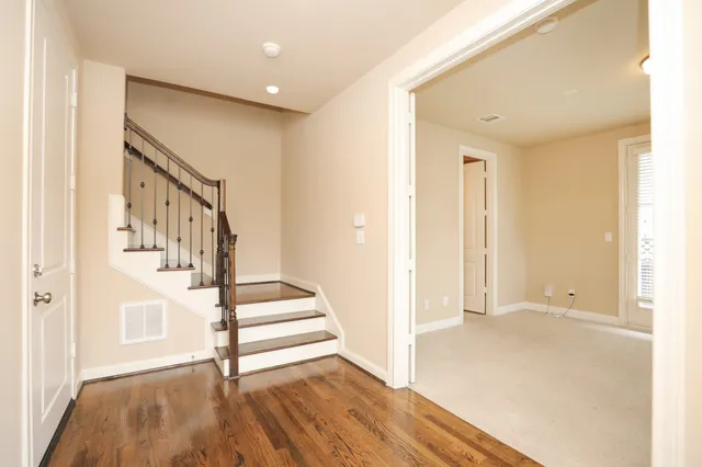 a view of entryway with wooden floor and stairs