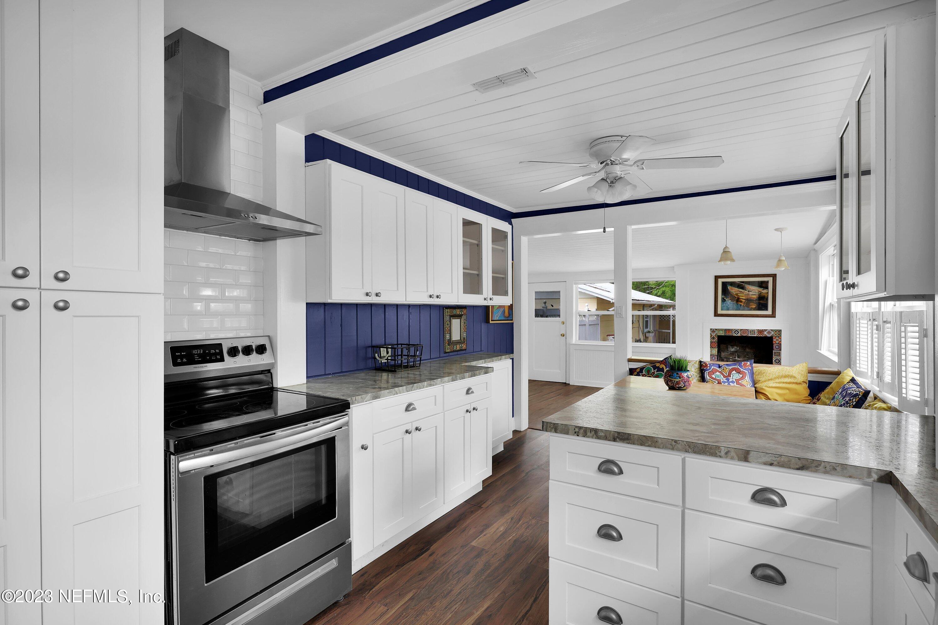 4 Florida Avenue St. Augustine, FL 32084 - Photo 7 of 52 a kitchen with granite countertop cabinets stainless steel appliances and wooden floor