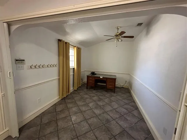 a view of a hallway to a livingroom with furniture