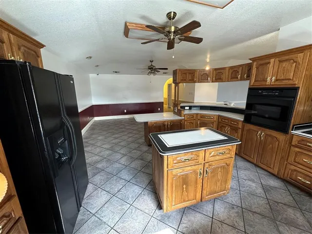 a kitchen with a stove a refrigerator and cabinets