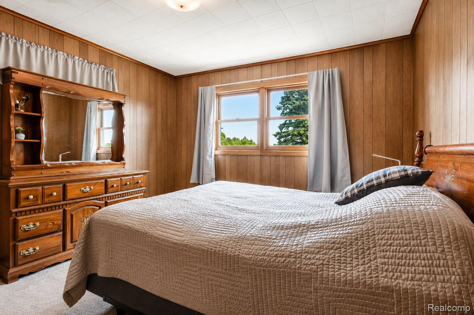 6373 Norman Road Jeddo, MI 48032 - Photo 8 of 32 Bedroom featuring wood walls and carpet flooring