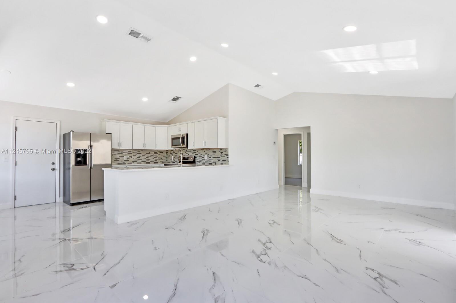 112 Raintree Trail Jupiter, FL 33458 - Photo 12 of 37 a view of kitchen with refrigerator cabinets and window