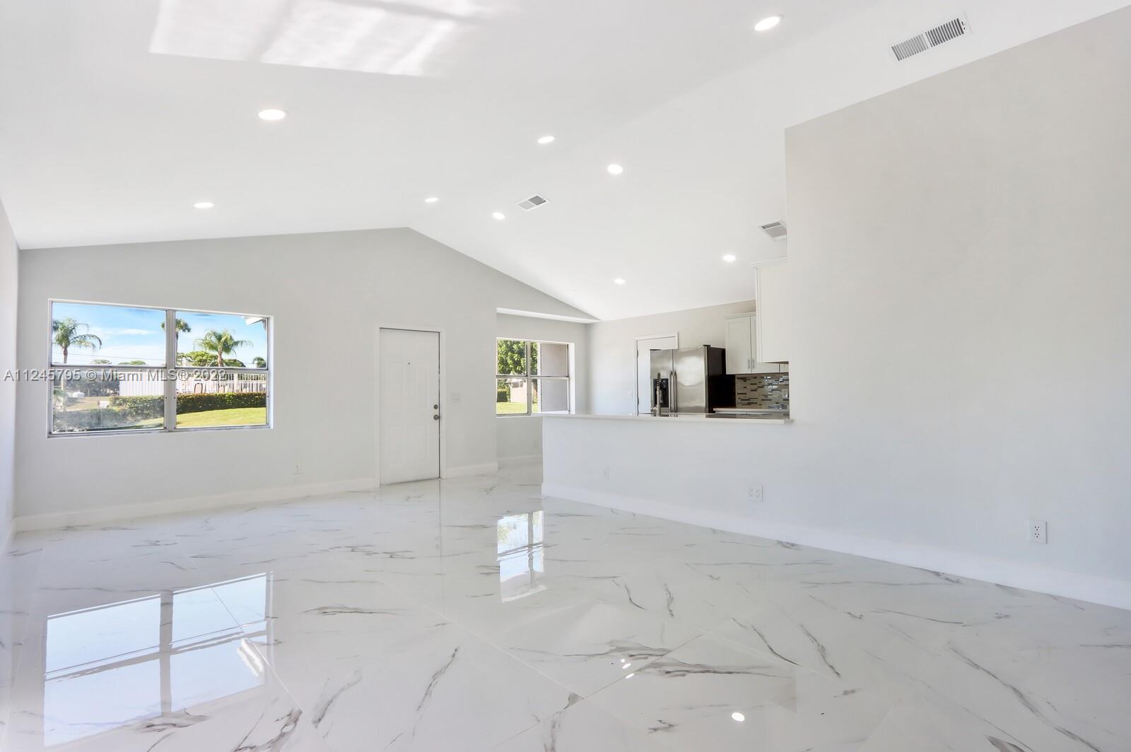 112 Raintree Trail Jupiter, FL 33458 - Photo 14 of 37 a view of a livingroom with wooden floor and window