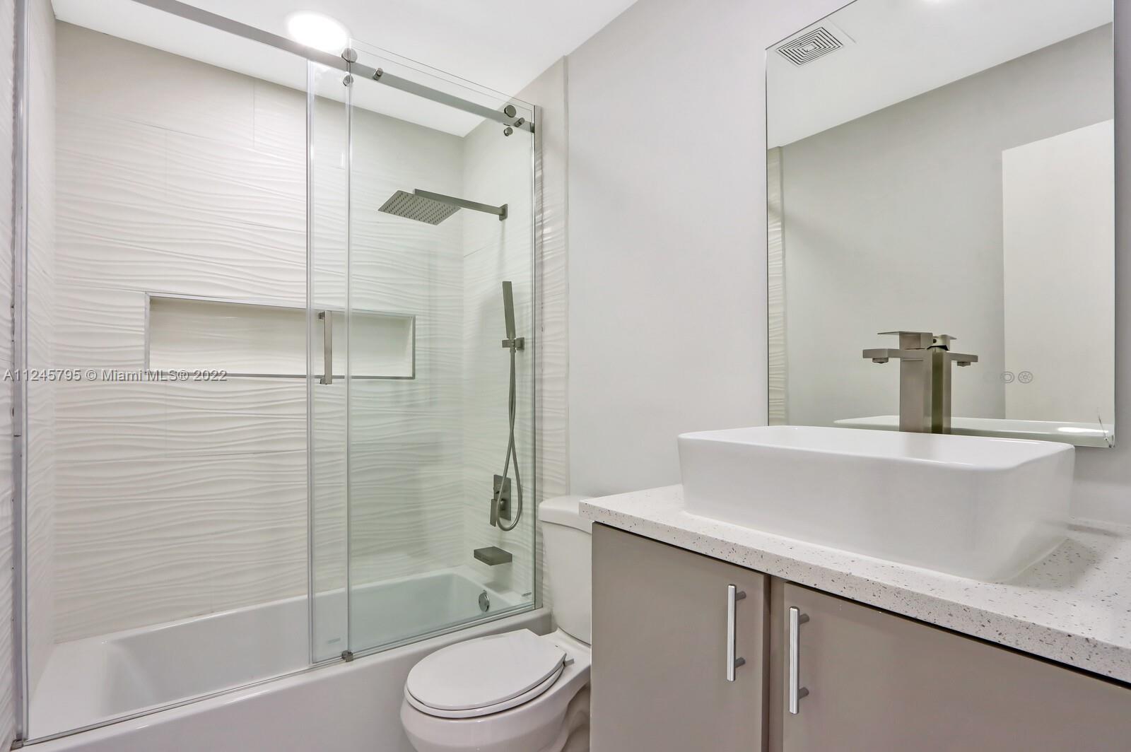 112 Raintree Trail Jupiter, FL 33458 - Photo 25 of 37 a bathroom with a sink a toilet and shower