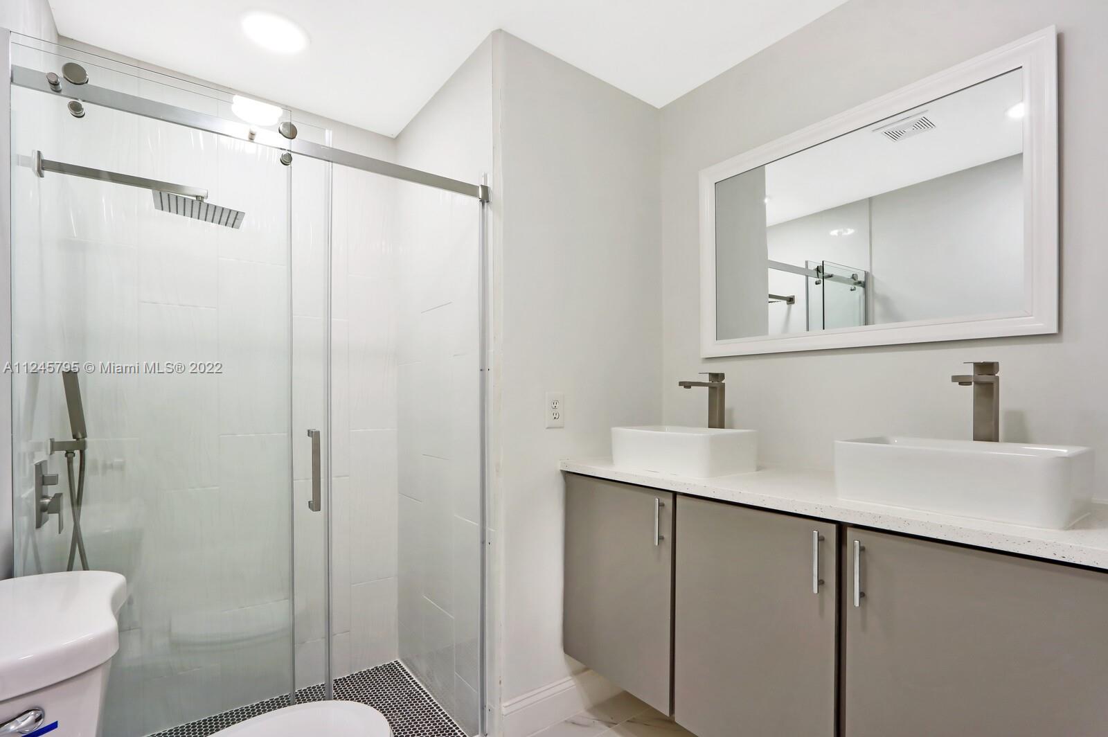 112 Raintree Trail Jupiter, FL 33458 - Photo 27 of 37 a bathroom with a sink vanity mirror and toilet