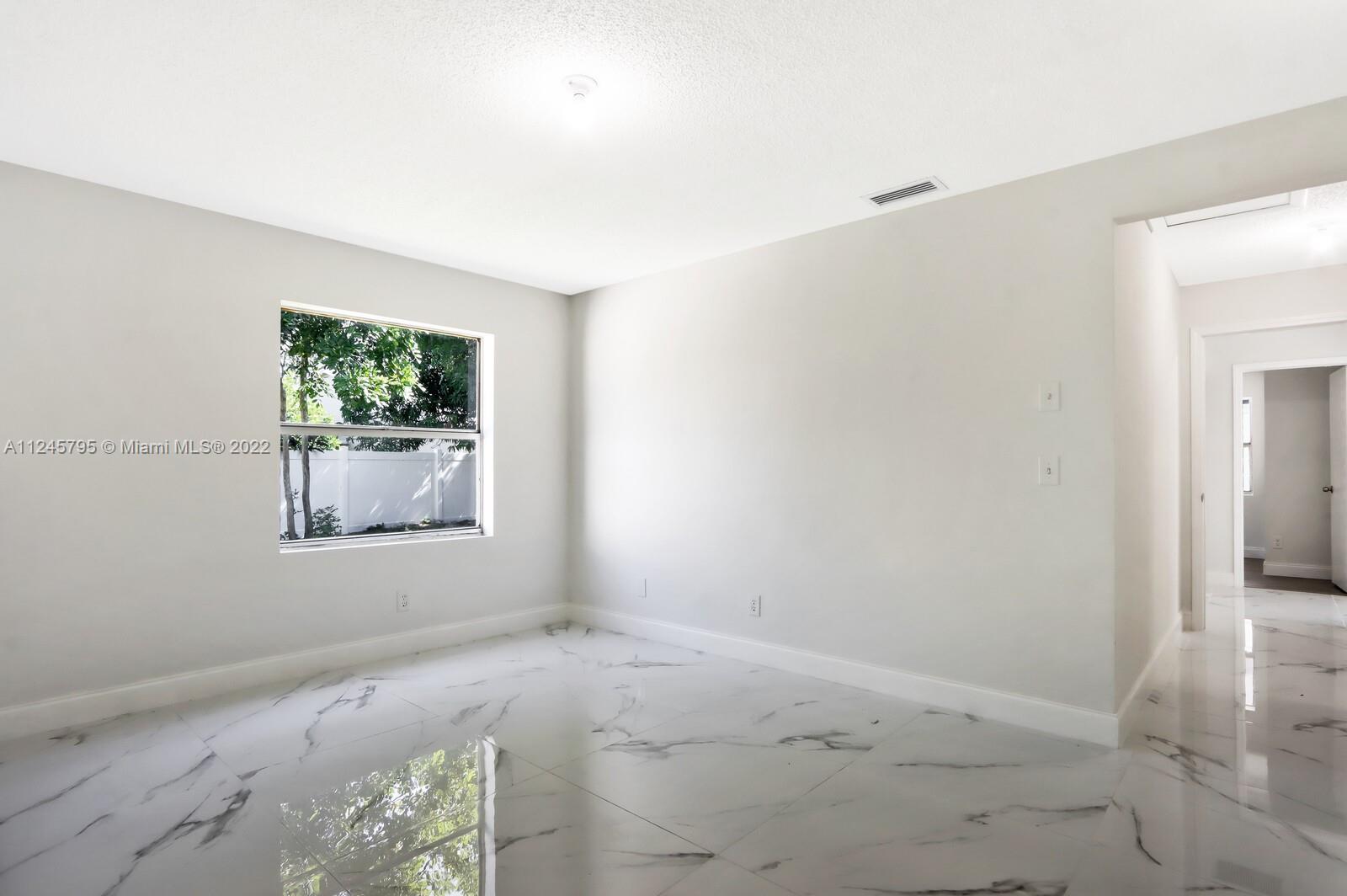 112 Raintree Trail Jupiter, FL 33458 - Photo 29 of 37 an empty room with windows